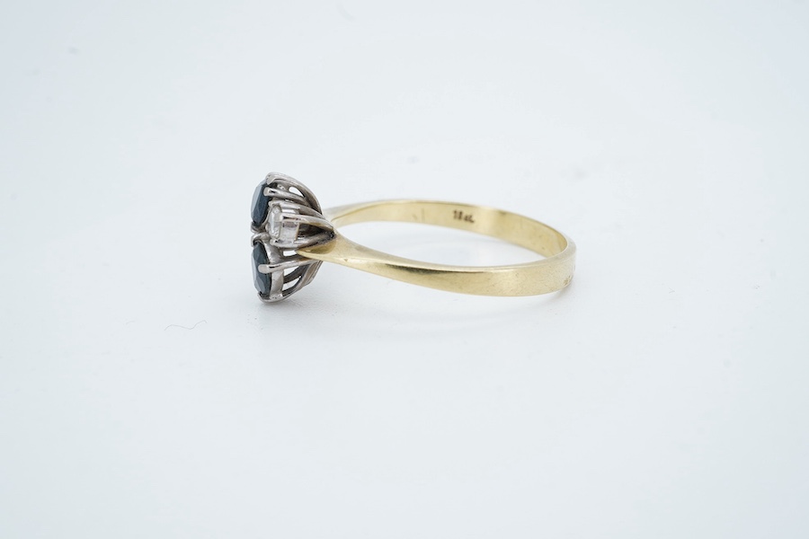 An 18ct two stone pear cut sapphire and two stone diamond cluster set ring, size P/Q, gross weight 3 grams. Condition - fair